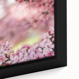 Close-up of a black framed canvas featuring textured, colorful art depicting spring, ideal for living room decor.