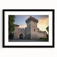Framed landscape artwork showcasing a majestic castle surrounded by lush greenery, presented in a sleek black mat and frame, ideal for home decor.