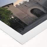 Landscape canvas print showcasing a majestic castle surrounded by vibrant greenery and a clear blue sky, rolled and ready for display in a durable cardboard tube. Perfect for home decor enthusiasts seeking a touch of elegance and charm.