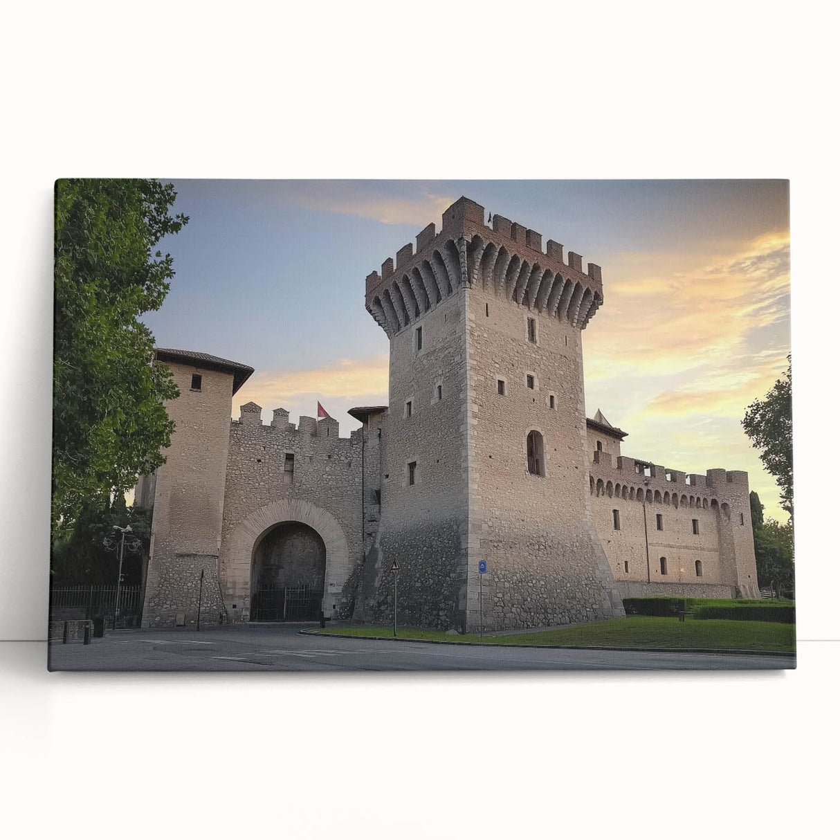 Stretched canvas artwork depicting a picturesque landscape with a majestic castle surrounded by lush greenery and a vibrant blue sky, perfect for home decor.