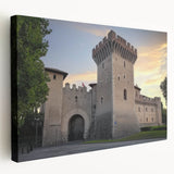 Stretched canvas artwork depicting a serene landscape with a majestic castle surrounded by lush greenery and a clear blue sky, ideal for home decor.