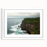 Framed landscape artwork depicting dramatic cliffs in a serene setting, featuring a white mat and sleek black frame, ideal for modern home decor.