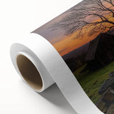 Rolled canvas showcasing a vibrant landscape design with rustic barn imagery, featuring rich colors and textured details, securely packaged in a protective tube.