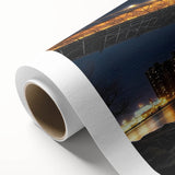 Rolled canvas showcasing a vibrant landscape bridge design, featuring rich colors and intricate details, packaged securely in a durable cardboard tube for safe shipping.