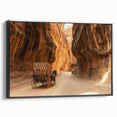 Framed canvas artwork depicting a stunning landscape of canyons, showcasing vibrant earthy tones and intricate details, presented in a sleek black frame for modern decor.