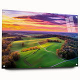 Acrylic glass artwork depicting a serene countryside landscape with vibrant green fields and a clear blue sky, showcased from a side view with decorative pins for hanging.