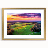 Elegant gold-framed countryside landscape artwork with a white mat, showcasing serene rolling hills and a vibrant sky, ideal for home decor and wall art enthusiasts.