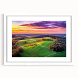 Countryside landscape framed art print with a white mat, showcasing vibrant green fields and a clear blue sky, perfect for home decor or office settings.
