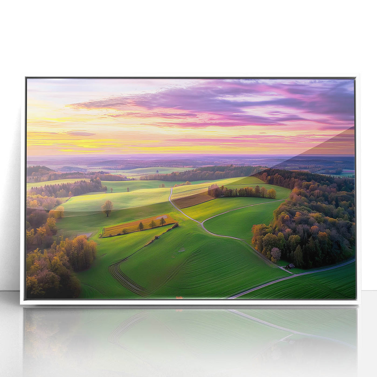 Framed acrylic landscape artwork depicting a serene countryside scene with vibrant greens and soft blues, set in a sleek white frame, ideal for home decor.