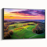 Framed canvas artwork depicting a serene countryside landscape with rolling hills and lush greenery, presented in a stylish black frame for an elegant touch.