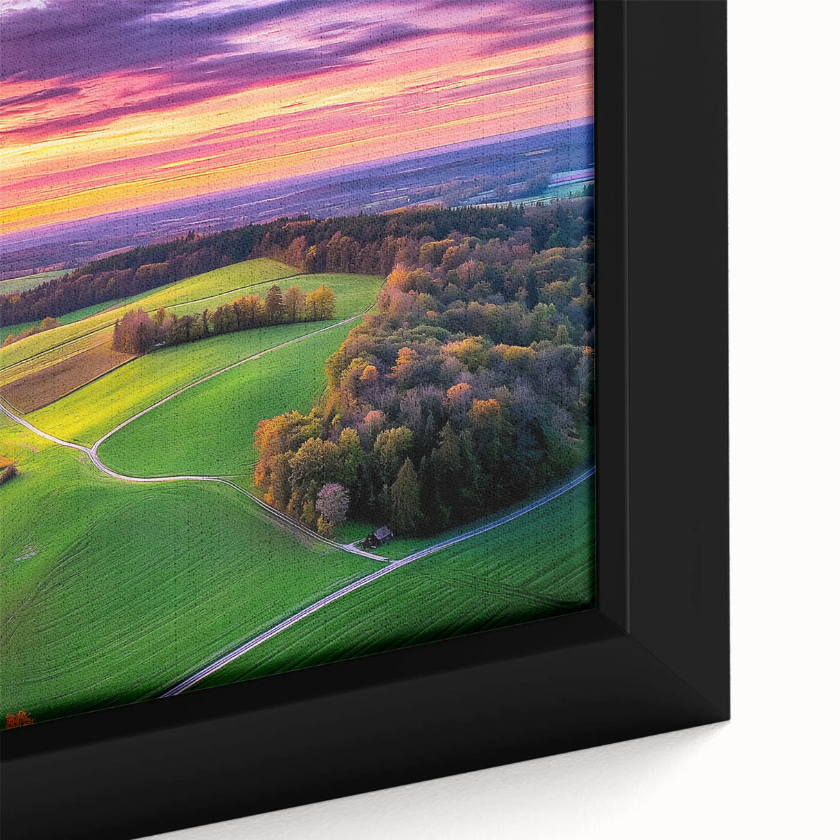 Close-up view of a framed canvas showcasing a serene countryside landscape, featuring lush green fields and a tranquil blue sky, ideal for home decor.