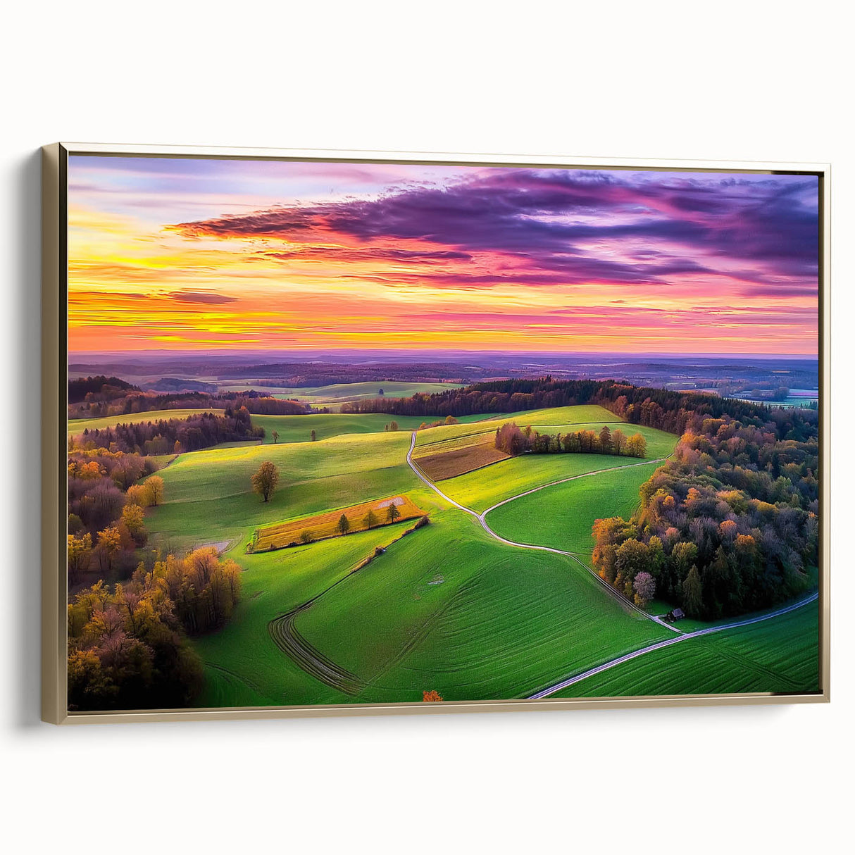 Framed canvas artwork showcasing a serene countryside landscape with vibrant green fields and rolling hills, elegantly bordered with gold trim for a luxurious finish.
