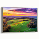 Framed canvas art showcasing a serene countryside landscape, featuring lush green fields and distant hills, with a sleek silver frame enhancing its elegance.