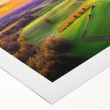 Rolled canvas artwork depicting a serene countryside landscape with lush green fields and rolling hills, beautifully packaged in a protective tube for easy transport.