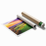 Rolled print of a vibrant countryside landscape featuring lush green fields and rolling hills under a bright blue sky, packaged securely in a protective tube.
