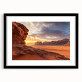 Framed desert landscape artwork featuring vibrant hues of orange and yellow, encased in a sleek black frame with a mat for a polished look, ideal for home décor.