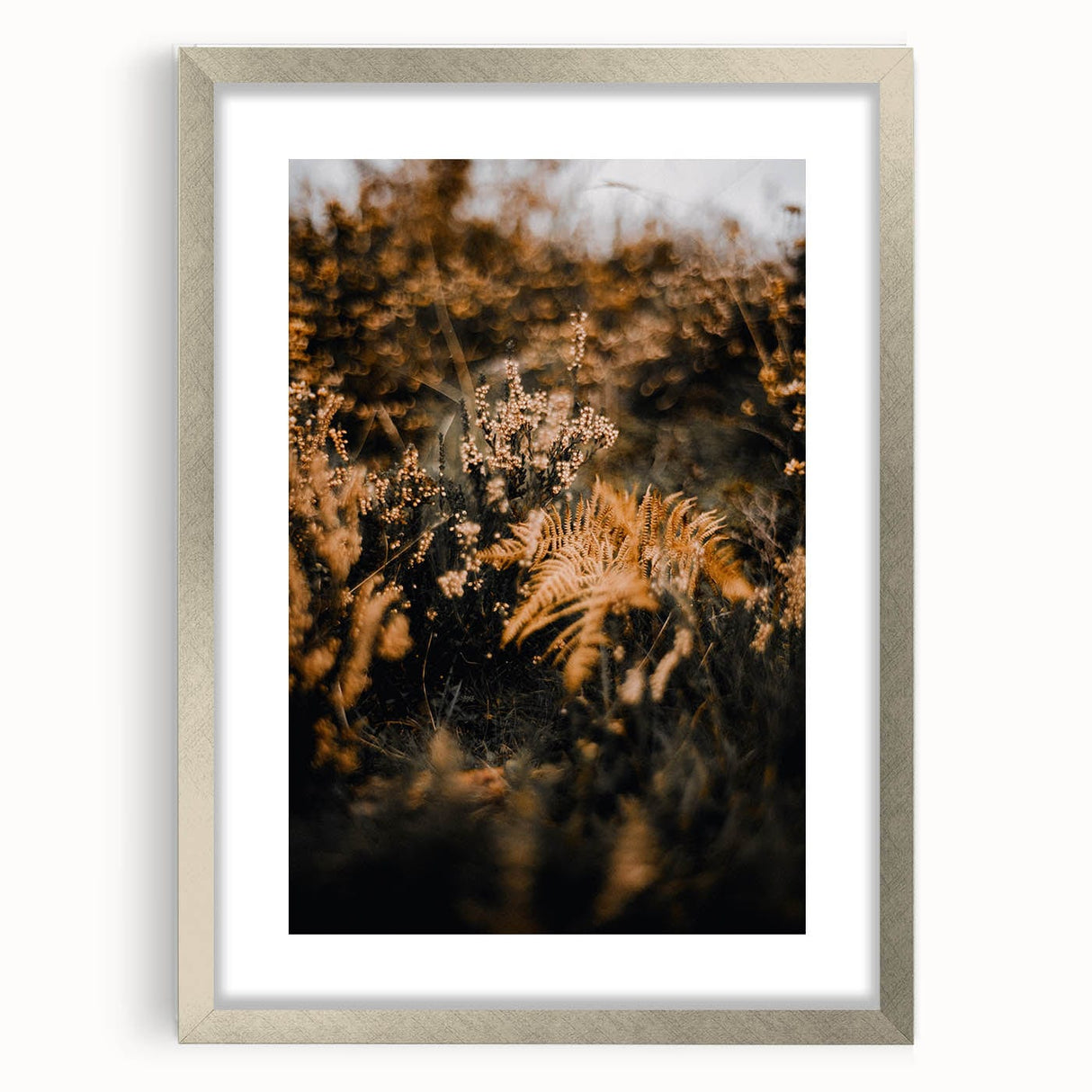 Textured art depicting abstract fall colors in silver frame, ideal for bedroom ambiance.