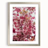 Textured abstract art print featuring swirling spring hues on a silver-framed canvas, ideal for bedroom ambiance.