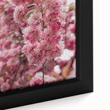 Close-up of a black framed canvas featuring a textured, colorful abstract design, ideal for living room decor.