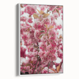 Vintage poster art of spring season with colorful floral motifs on a framed canvas, ideal for living room decor.