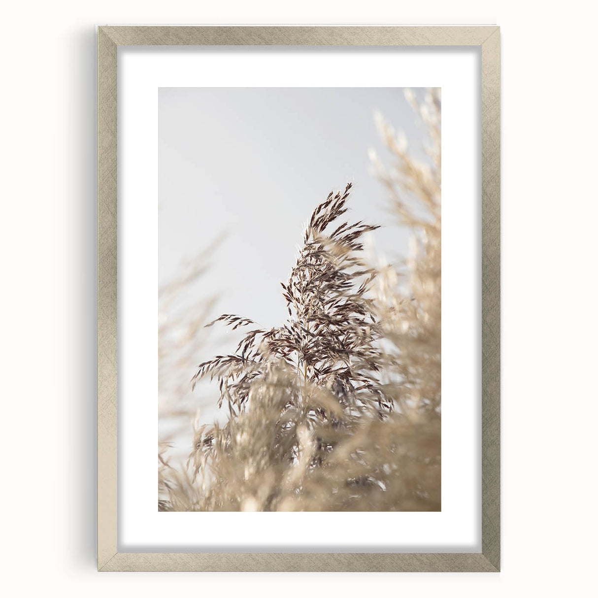 Textured abstract art print in warm yellow and orange tones on a silver-framed canvas, ideal for bedroom art.