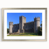 Framed landscape artwork showcasing a picturesque castle scene, bordered by a silver mat, perfect for home décor and enhancing interior aesthetics.