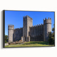 Framed canvas artwork showcasing a picturesque landscape featuring a majestic castle, with a sleek black frame enhancing its elegance. The vivid colors and intricate details create a stunning visual centerpiece for home decor.