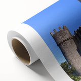 Rolled canvas artwork showcasing a stunning landscape of a castle surrounded by lush greenery, elegantly packaged in a protective cardboard tube for safe shipping.