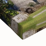 Close-up of a stretched canvas featuring a vibrant landscape painting of a majestic castle surrounded by lush greenery, capturing intricate details and rich colors, perfect for home decor or art lovers.