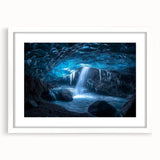 Framed landscape artwork showcasing a stunning cave scene, featuring rich earth tones and intricate details, presented in a white mat for a polished look.
