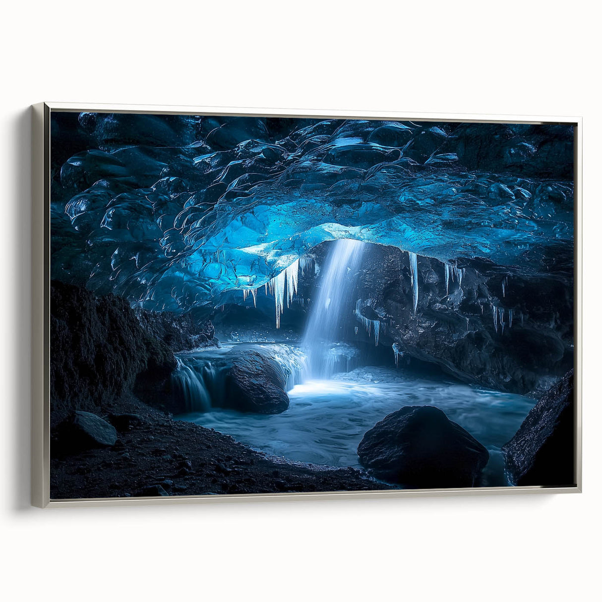 Framed canvas artwork depicting a serene landscape with caves, presented in a sleek silver frame, ideal for enhancing modern home décor and art collections.