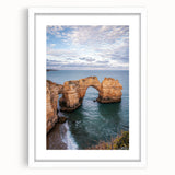 White-framed landscape art featuring dramatic cliffs and a serene sky, designed to enhance home decor with its vibrant colors and scenic beauty. Perfect for nature enthusiasts.