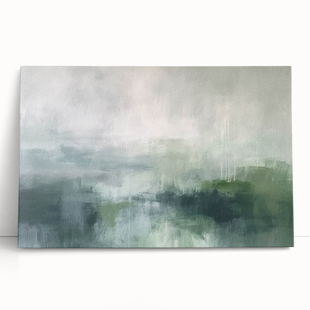 Abstract landscape wall art on stretched canvas, featuring soft blues and greens with textured brush strokes, creating a serene and modern decor accent for homes.