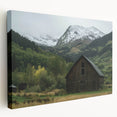 Stretched canvas artwork depicting a serene landscape featuring a rustic barn surrounded by lush greenery, ideal for home decor enthusiasts.