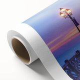 Rolled canvas showcasing a vibrant landscape bridge design, featuring rich colors and intricate details, securely packaged in a durable cardboard tube for safe delivery.