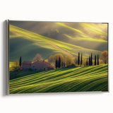 Framed canvas artwork showcasing a picturesque countryside landscape, featuring lush greenery and rolling hills, presented in a sleek silver frame for a modern touch.
