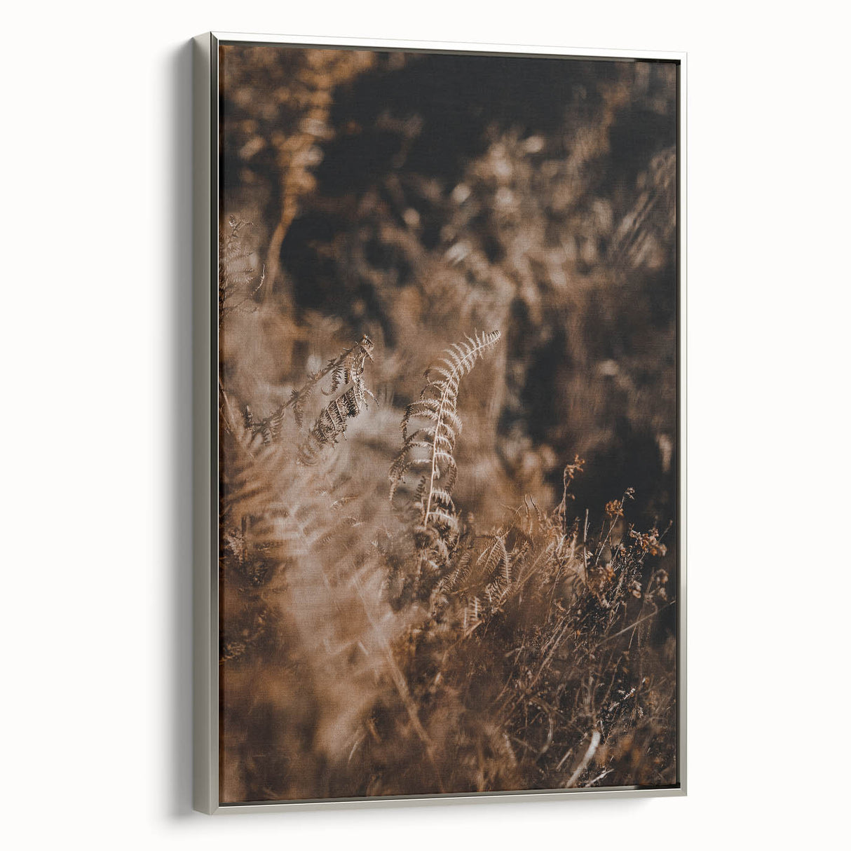 Framed canvas of a vintage landscape art painting featuring autumn trees in vibrant orange and red tones.