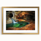 Elegant gold-framed landscape artwork depicting a serene cave scene, showcasing intricate details and vibrant colors, perfect for enhancing home decor.
