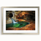 Framed landscape artwork displaying intricately designed caves, highlighted by a silver mat border. Ideal for home decor, adding elegance and depth to any space.