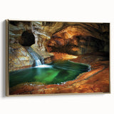 Framed canvas artwork showcasing a stunning landscape with intricate cave designs, accented by a gold frame, ideal for home decor and artistic displays.
