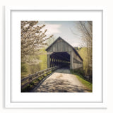 Abstract art print of a covered bridge in muted gray and blue tones on a framed white mat, ideal for dining room decor.