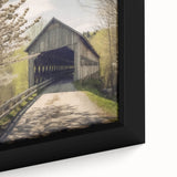 Close-up of a framed canvas featuring a black covered bridge with textured, colorful art accents.
