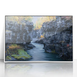 Framed acrylic artwork depicting a stunning landscape of canyons in vibrant colors, showcasing the beauty of nature. The piece is elegantly presented in a sleek white frame, perfect for enhancing modern home decor.