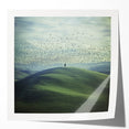 Glossy mockup of a countryside landscape photo print showcasing vibrant green fields and a clear blue sky, ideal for home decor or art displays. The print features rich colors and fine details, enhancing its visual appeal.