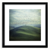 Black-framed landscape artwork featuring serene countryside scenery, presented with a white mat for an elegant finish, ideal for home decor.