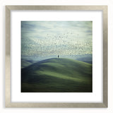 Elegant silver-framed landscape artwork depicting a serene countryside scene, complete with a white mat for added depth, ideal for home or office decor.