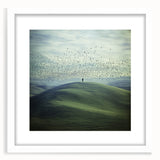 Elegant white-framed landscape artwork showcasing a serene countryside scene, complete with lush green fields and a clear blue sky, perfect for home decor.