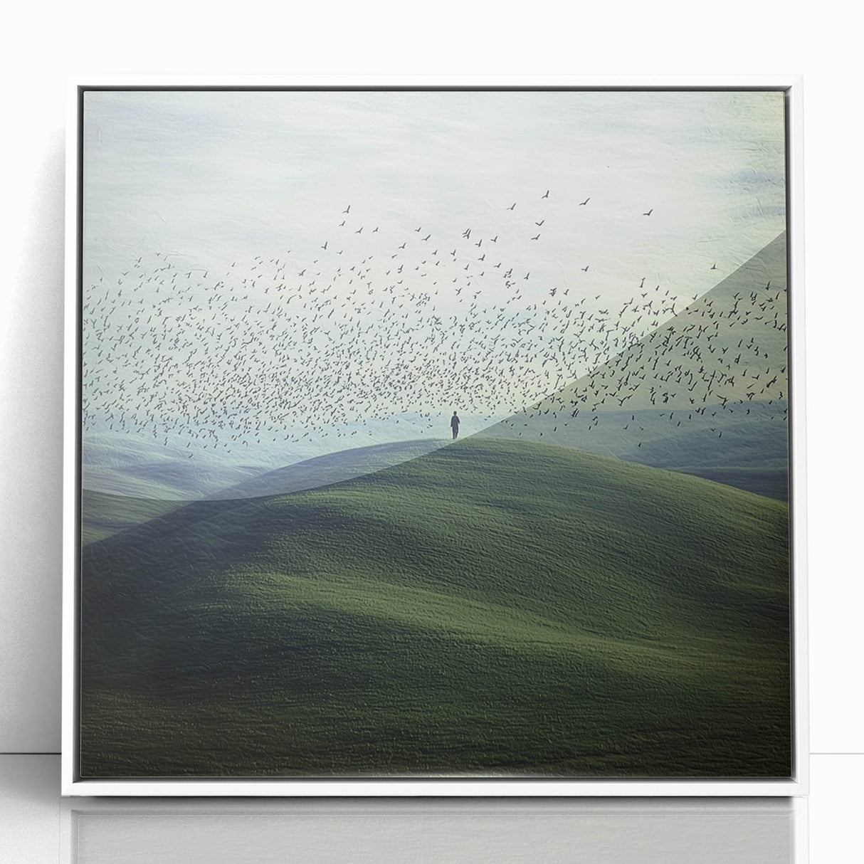 Framed acrylic landscape artwork showcasing a serene countryside scene with lush green fields and a bright blue sky, set in a modern white frame.