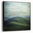 Framed black canvas showcasing a tranquil countryside landscape with rolling hills and a vibrant sunset, enhancing any room's decor with nature's beauty.