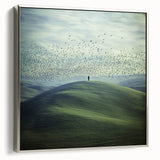 Framed canvas art depicting a serene countryside landscape, featuring lush greenery and rolling hills, with a sleek silver frame enhancing its elegance. Ideal for home decor.